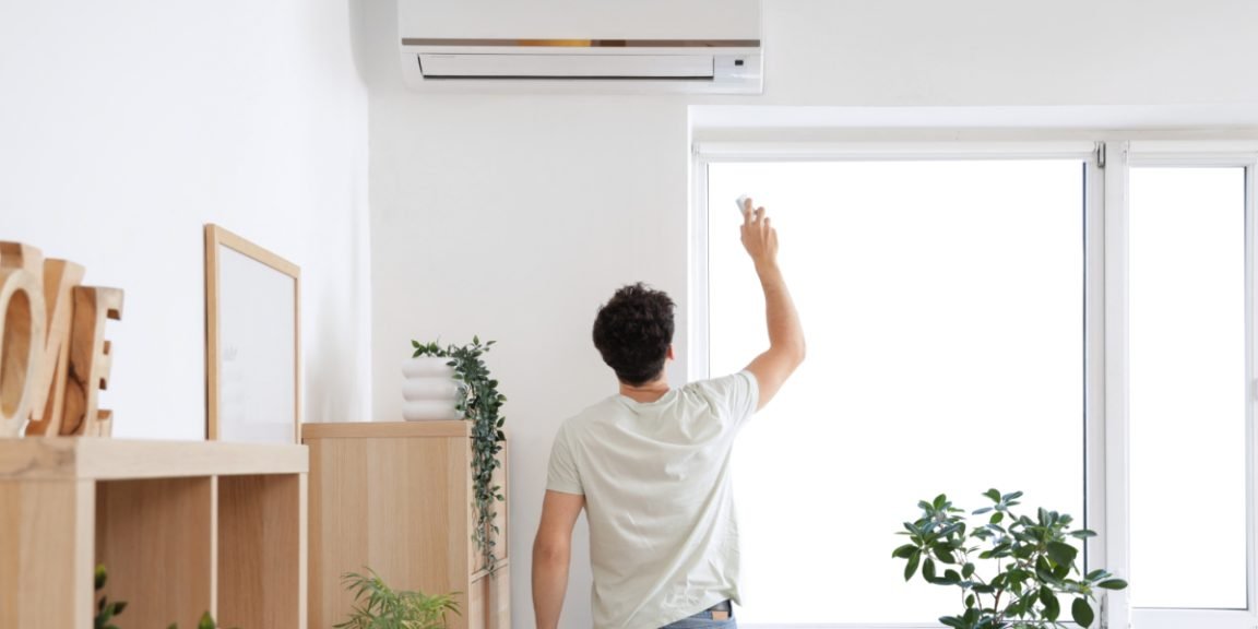 man opens the air condition shutterstock 2518107437 jpg