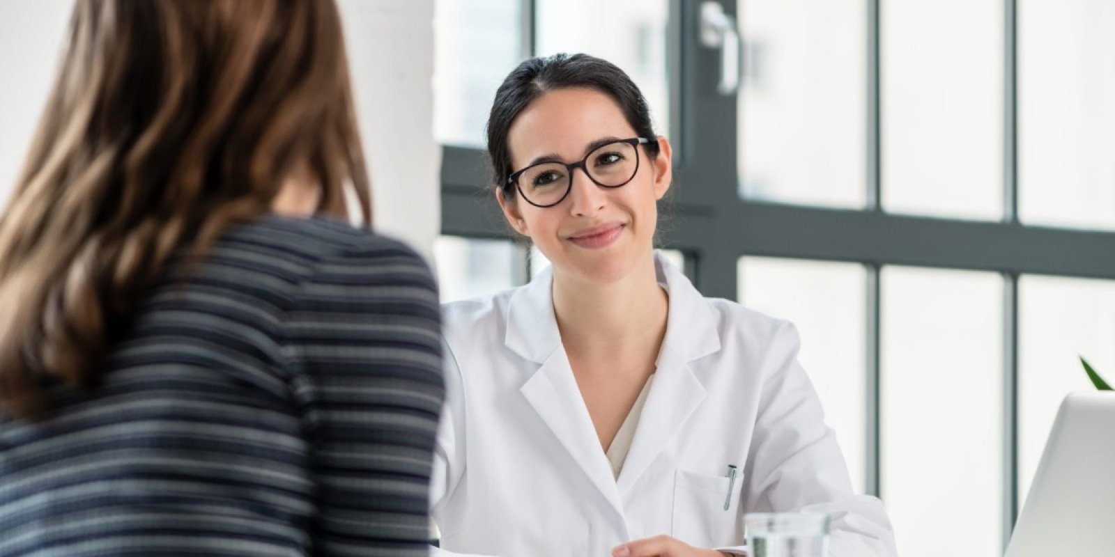 woman doctor with patient shutterstock 1035202660 jpg