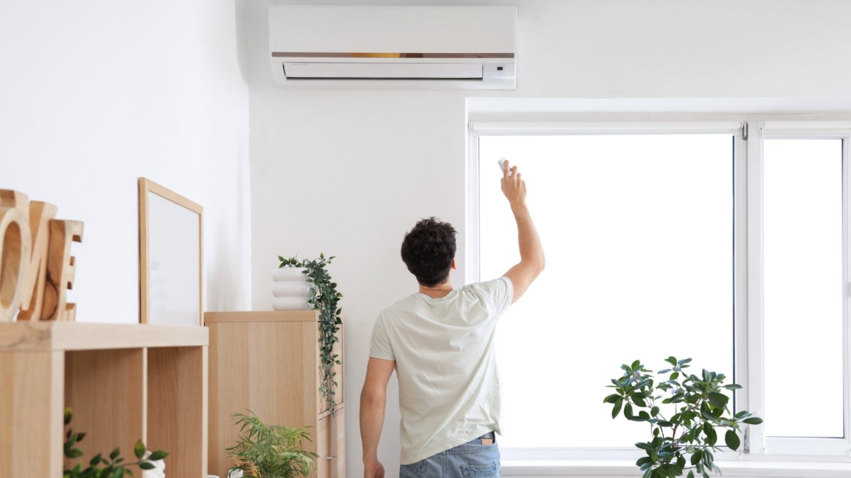 man opens the air condition shutterstock 2518107437 jpg