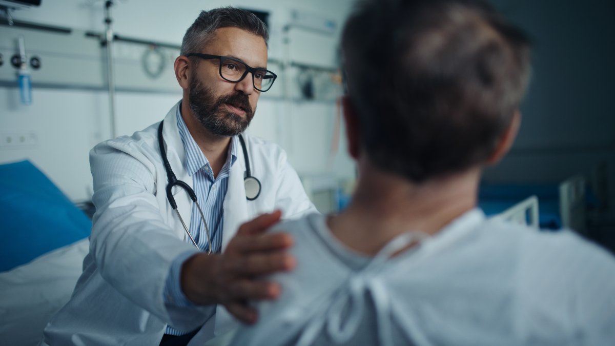 mature doctor with patient shutterstock 2231711111 jpg